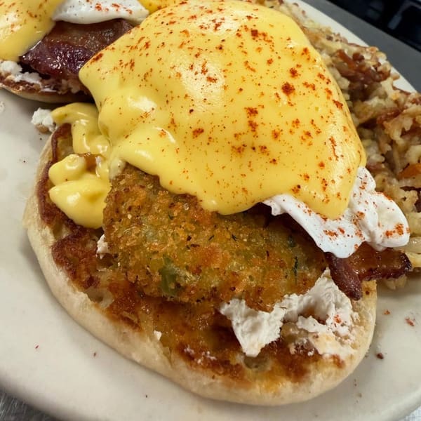 Eggs benedict under hollandaise and paprika